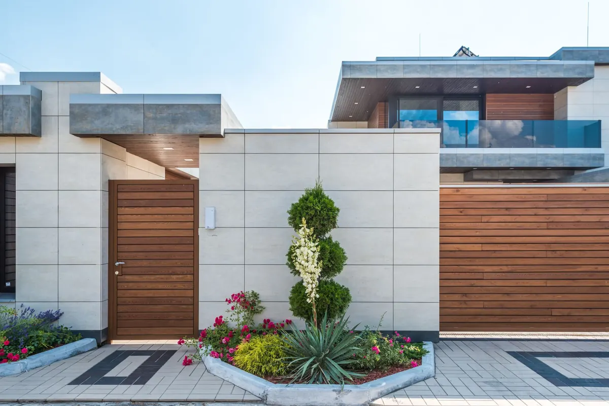 Front of a house with a healthy lawn and garden