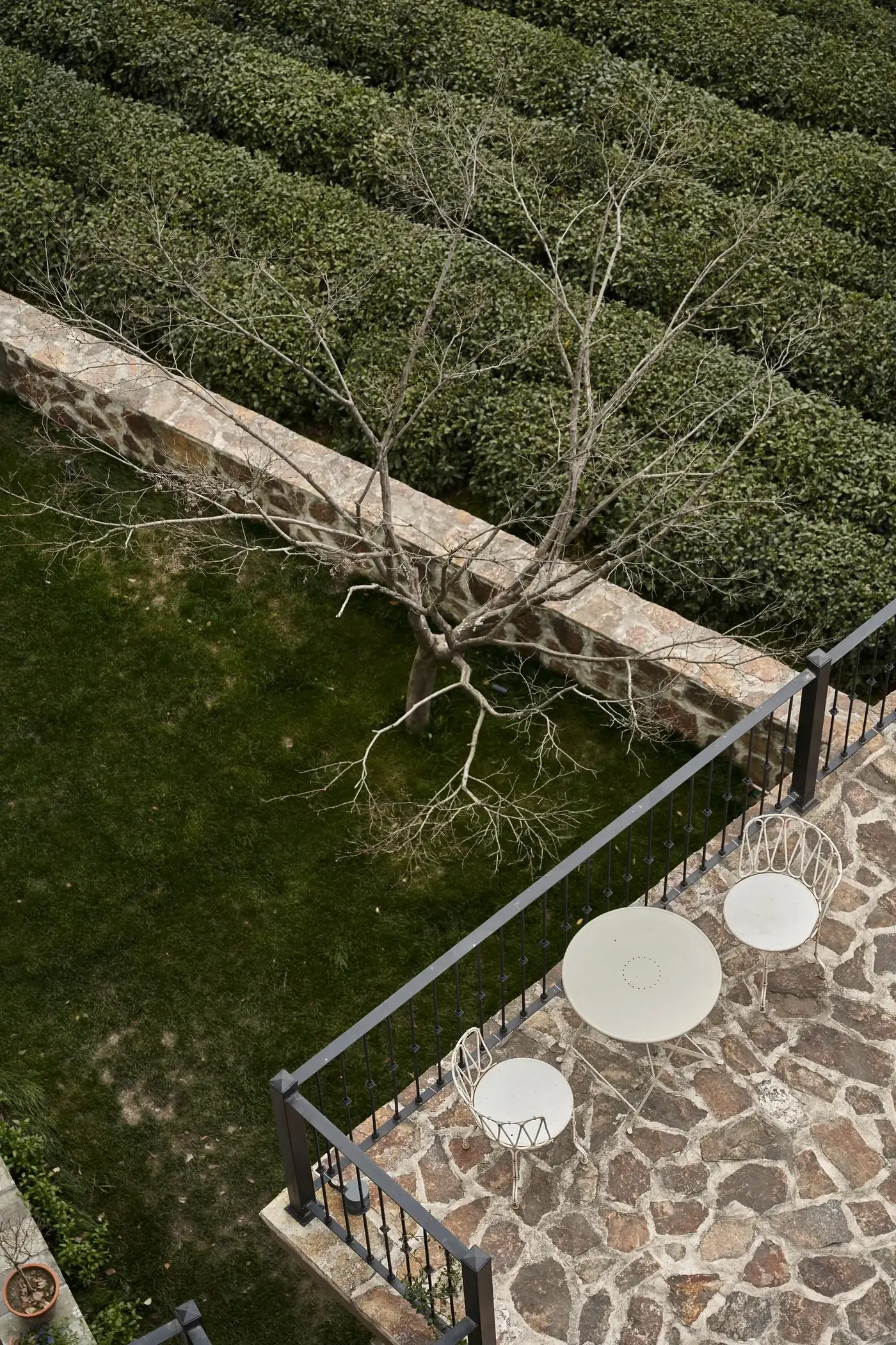 Stone patio beside a lush garden
