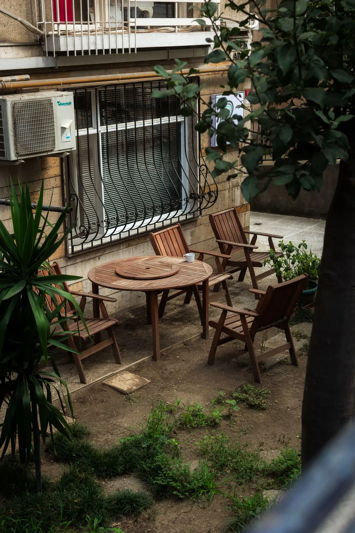 Quiet backyard patio with wooden chairs